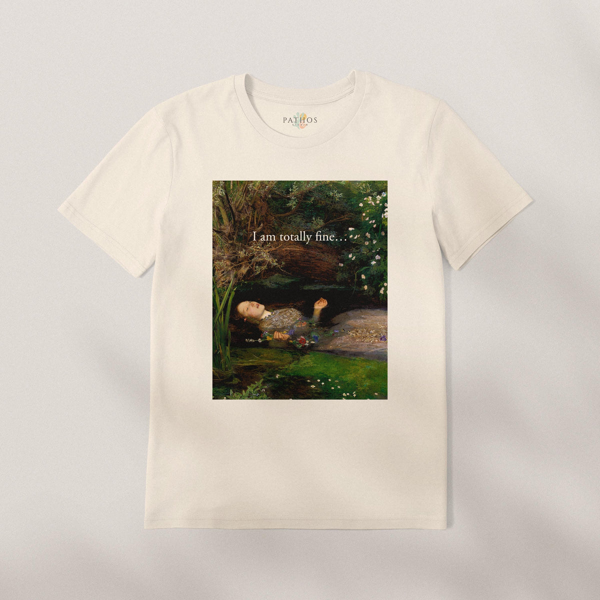 A white t-shirt with a printed image of a woman lying in a field with flowers, accompanied by the text "I am definitely fine..."