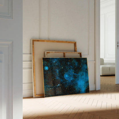 a large, vibrant painting of a starry night sky, with a blue and black color scheme, resting on a wooden floor in a room with white walls.