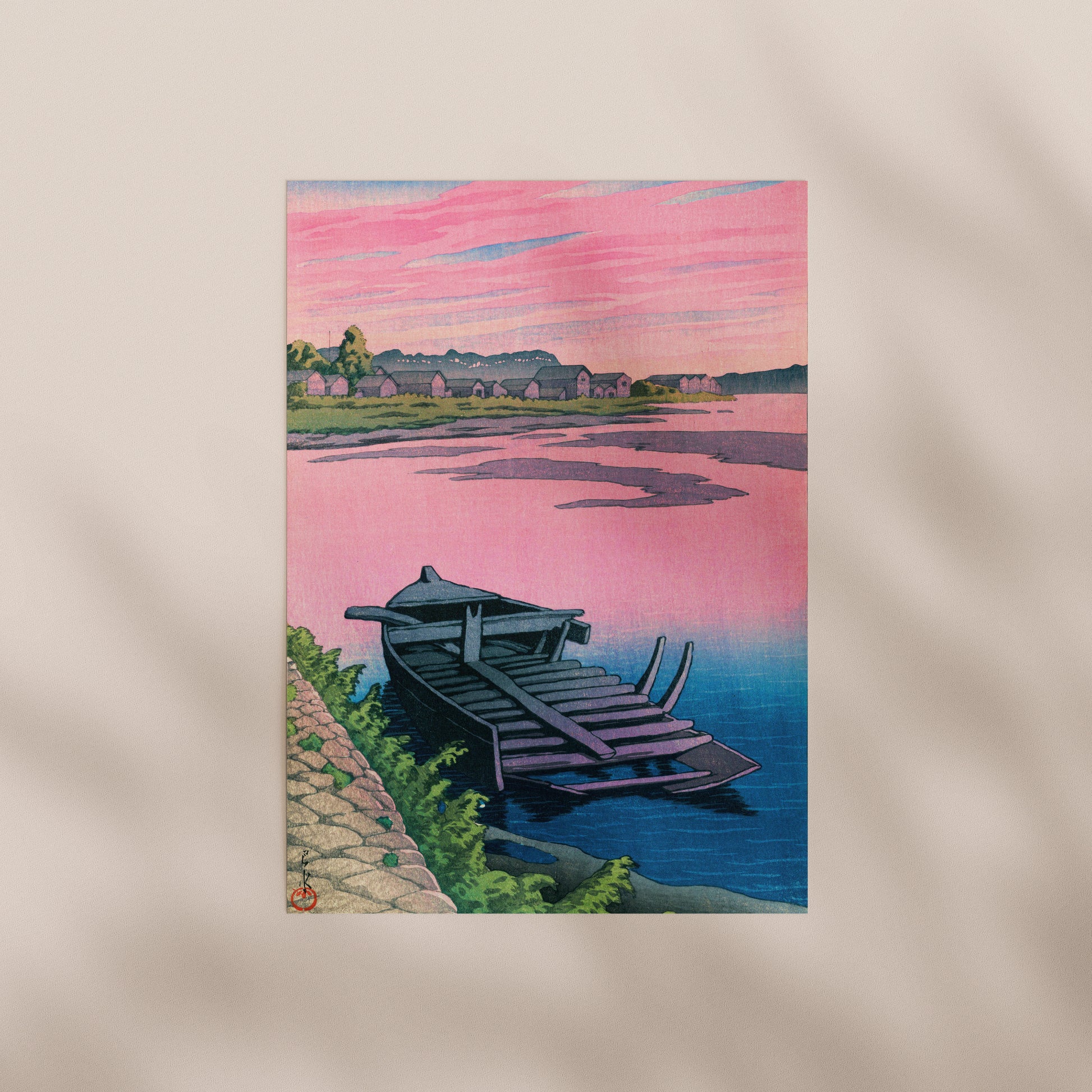 a serene scene of a small boat resting on the shore of a calm body of water, with a picturesque landscape in the background featuring a pink sky and silhouettes of trees and buildings.